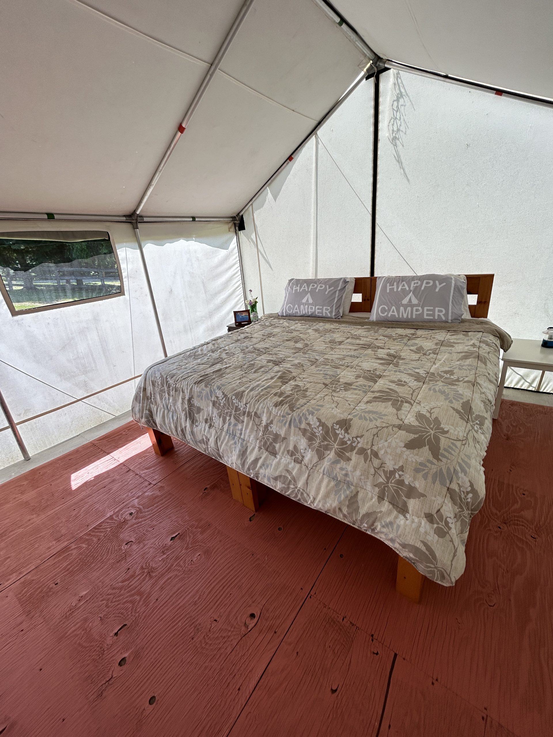 King bed inside The Gorge Tent in the pasture of Irvineside Farm.
